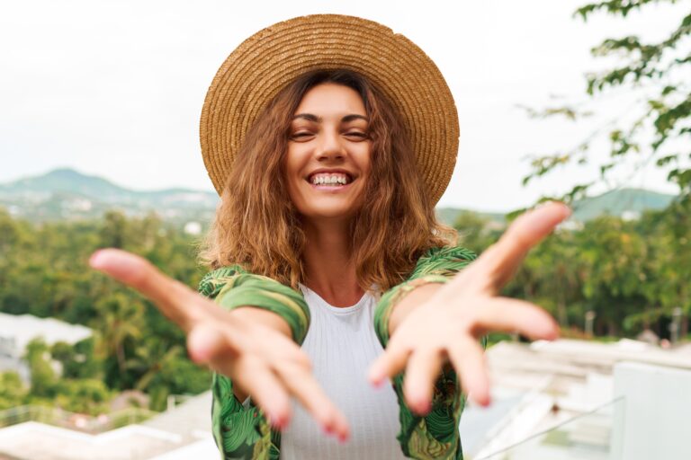 cheerful-woman-straw-hat-having-fun-stretches-hands-camera